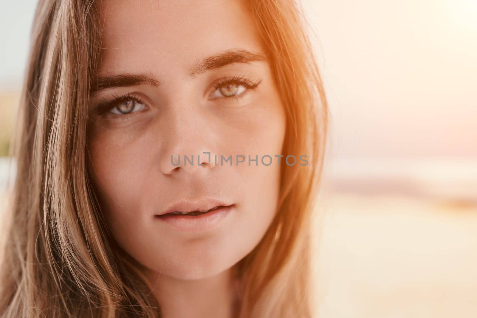 Happy woman portrait in cafe. Boho chic fashion style. Outdoor photo of young happy woman with long hair, sunny weather outdoors sitting in modern cafe. by panophotograph