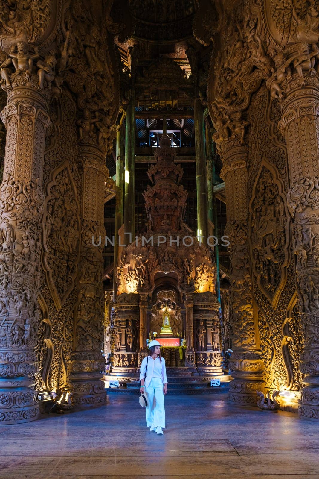 Asian women visit The Sanctuary of Truth wooden temple in Pattaya Thailand, sculpture of Sanctuary of Truth temple.