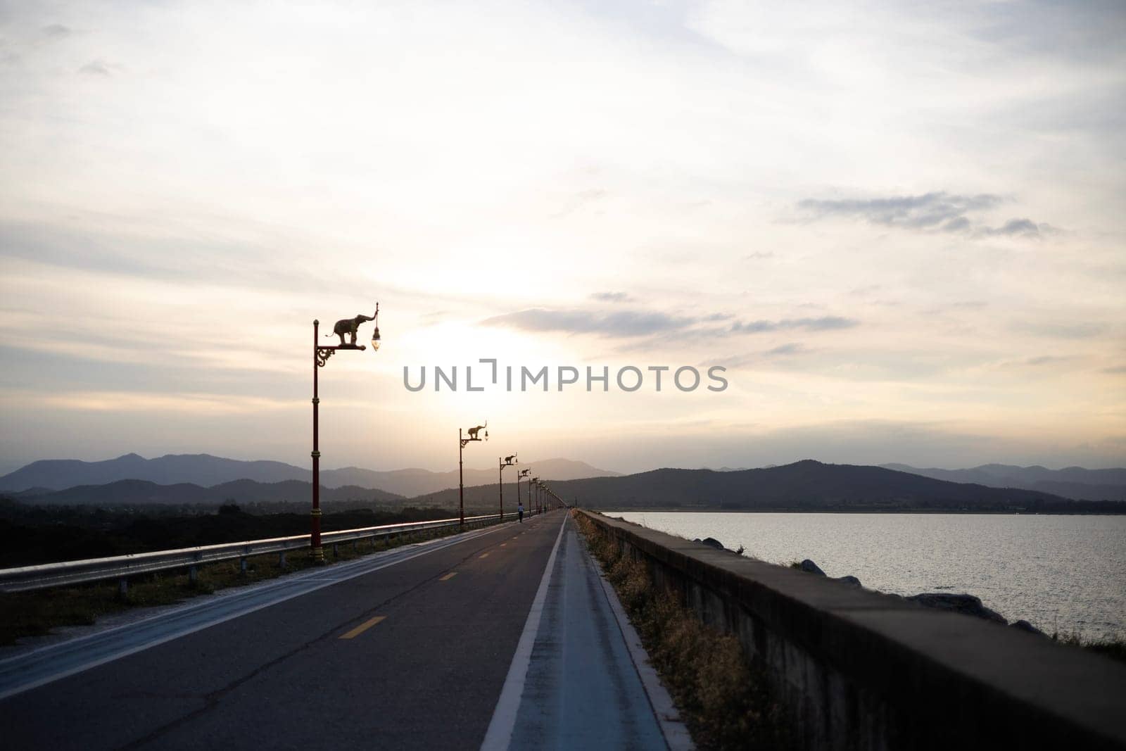 Empty Asphalt Road And Mountain Scenery At Sunset. Asphalt road and mountain with sky clouds at sunset.