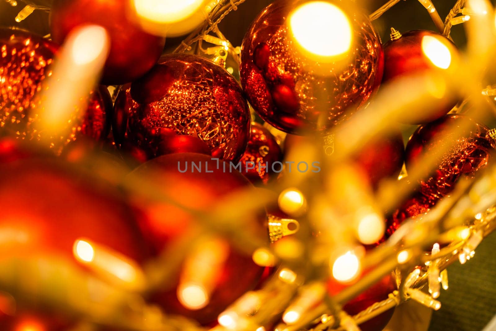 Red glowing Christmas balls garlands close-up. Holidays decoration and festive xmas concept. Copy space and empty place for text, mock up greeting card by Satura86