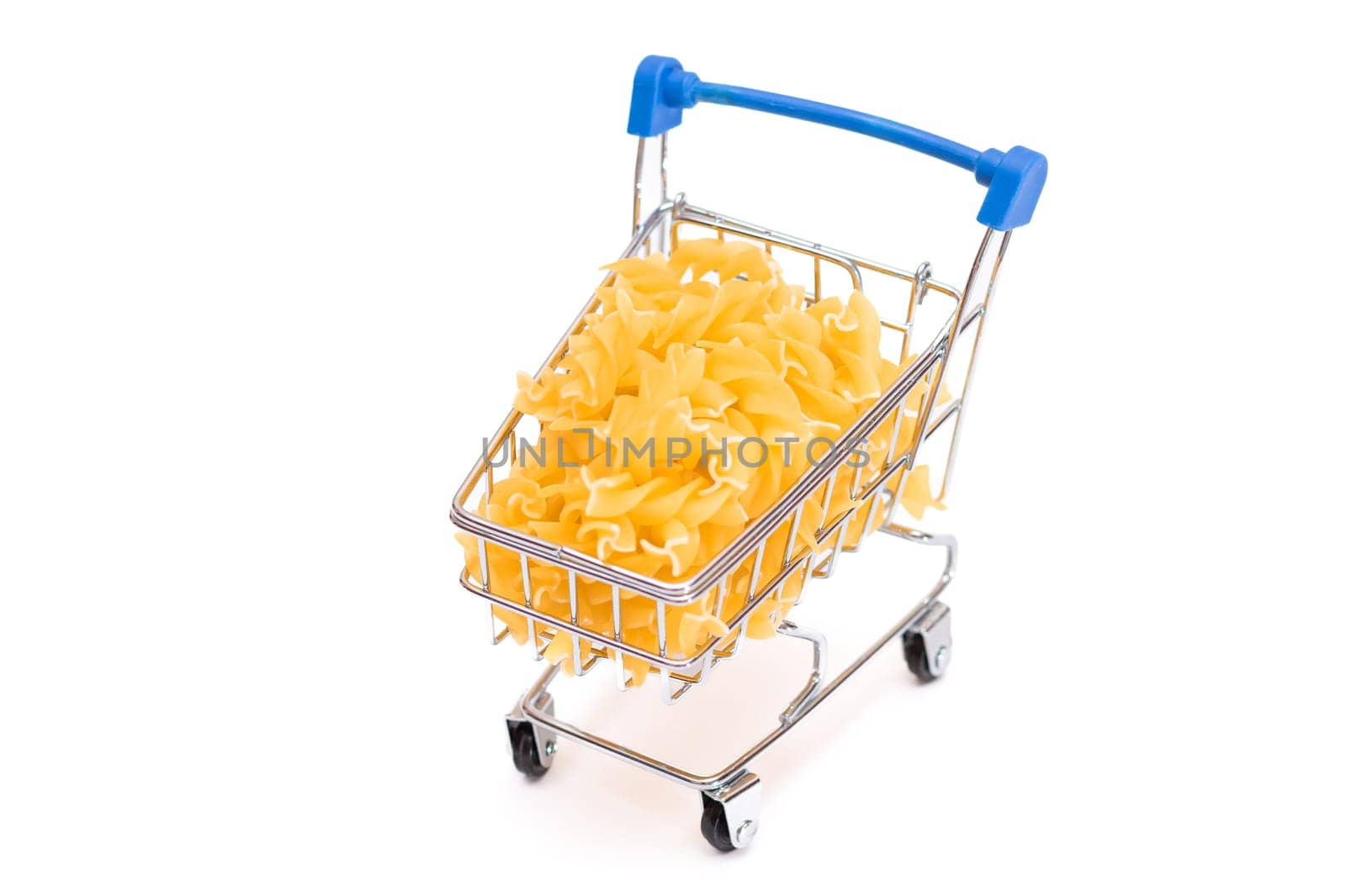 Uncooked Fusilli Pasta in Small Shopping Cart Isolated on White Background. A Crisis: Buying Cheap Food. Classic Dry Spiral Macaroni. Italian Culture and Cuisine. Raw Pasta - Isolation