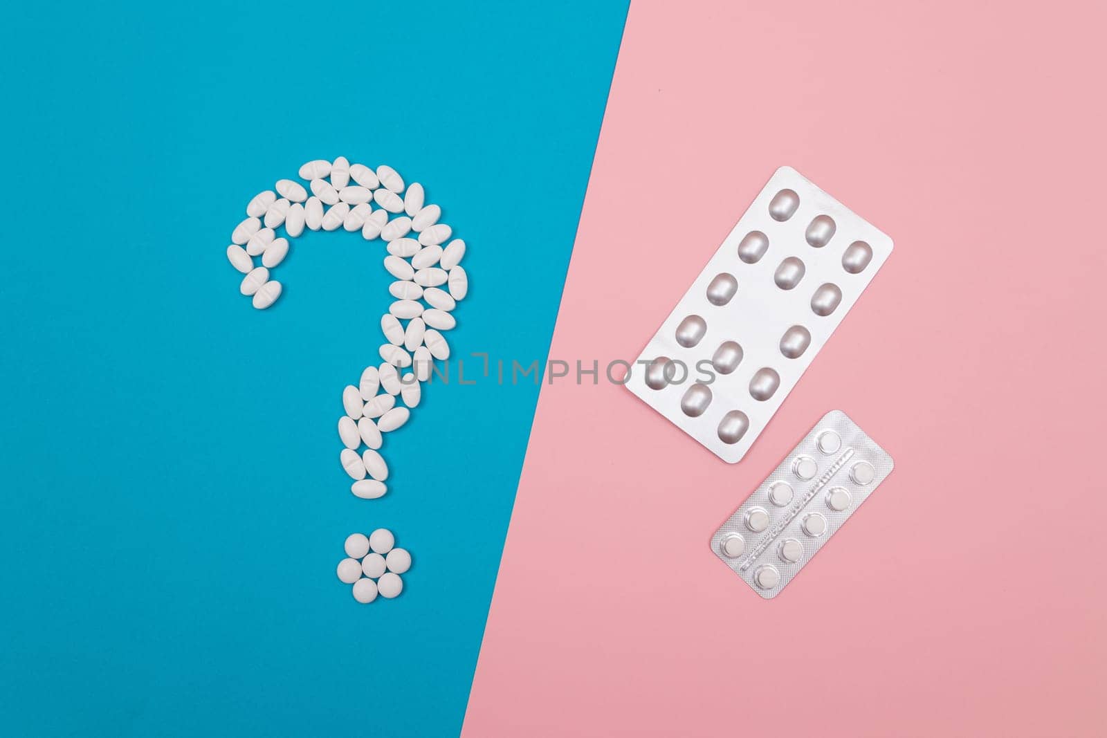 Question Mark Made from White Pills and Tablets with Pill Packages, Lying on Split Blue and Pink Background. Global Pharmaceutical Industry and Medicinal Products