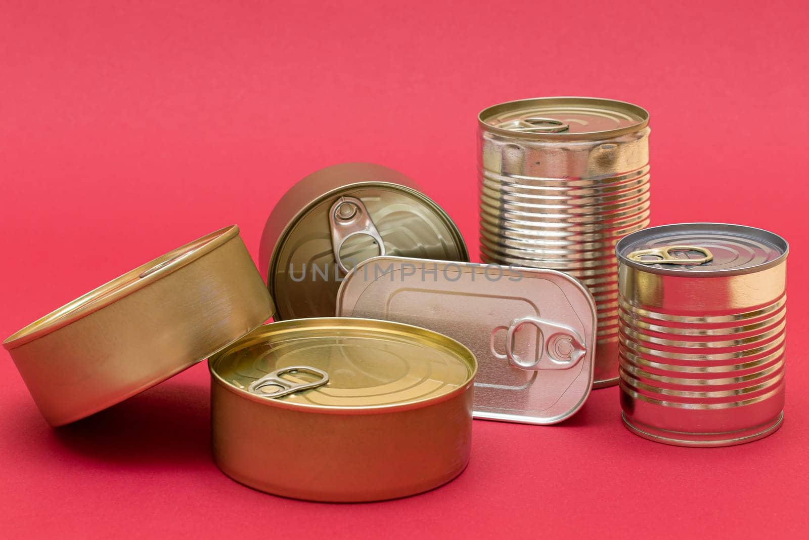 Unopened Tin Cans with Blank Edges on Red Background by InfinitumProdux