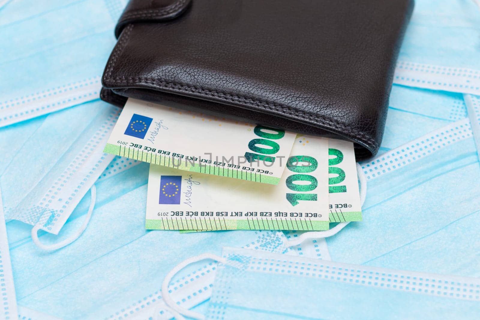 Black Men's Wallet with Euro Money Inside on the Blue Disposable Medical Face Masks by InfinitumProdux