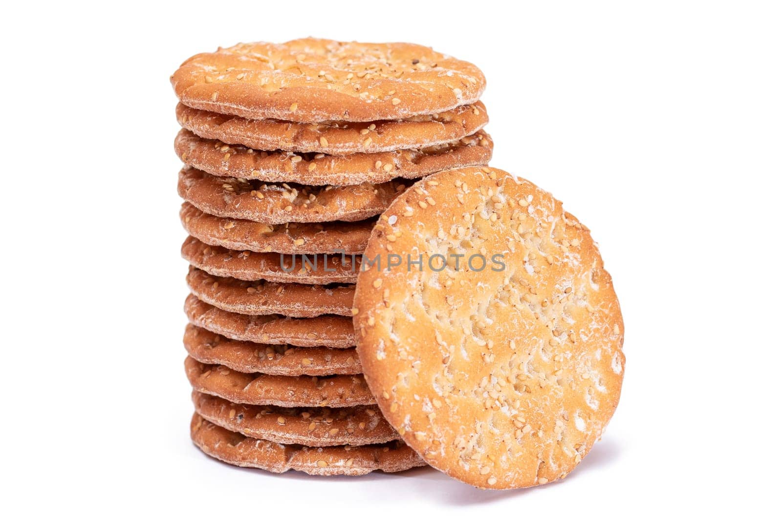 A Stack of Round Salt Crackers with Sesame Isolated on White Background by InfinitumProdux