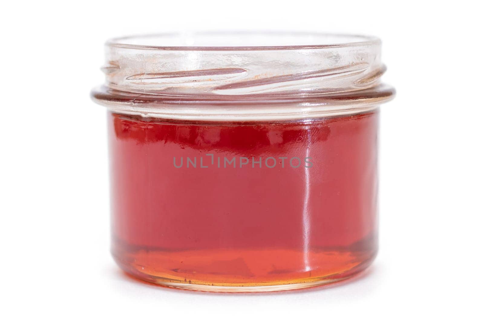 Dark Honey in a Small Glass Jar Isolated on White Background