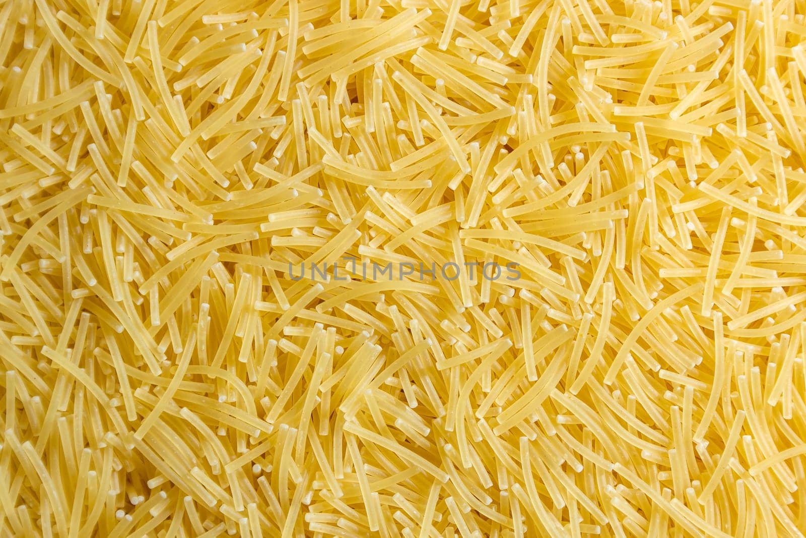 Uncooked Filini Pasta: A Culinary Canvas of Noodles, Creating a Lively and Textured Background for Gourmet Cooking. Dry Pasta. Raw Macaroni - Top View, Flat Lay