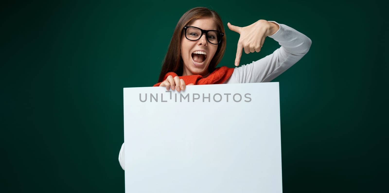 European young woman in white turtleneck showing board mockup by TRMK