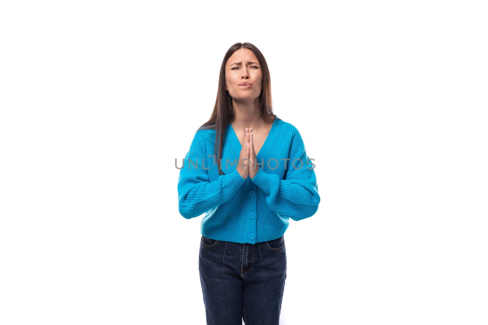 charming caucasian woman with black long straight hair is dressed in a blue sweater on a white background. people lightstyle concept by TRMK