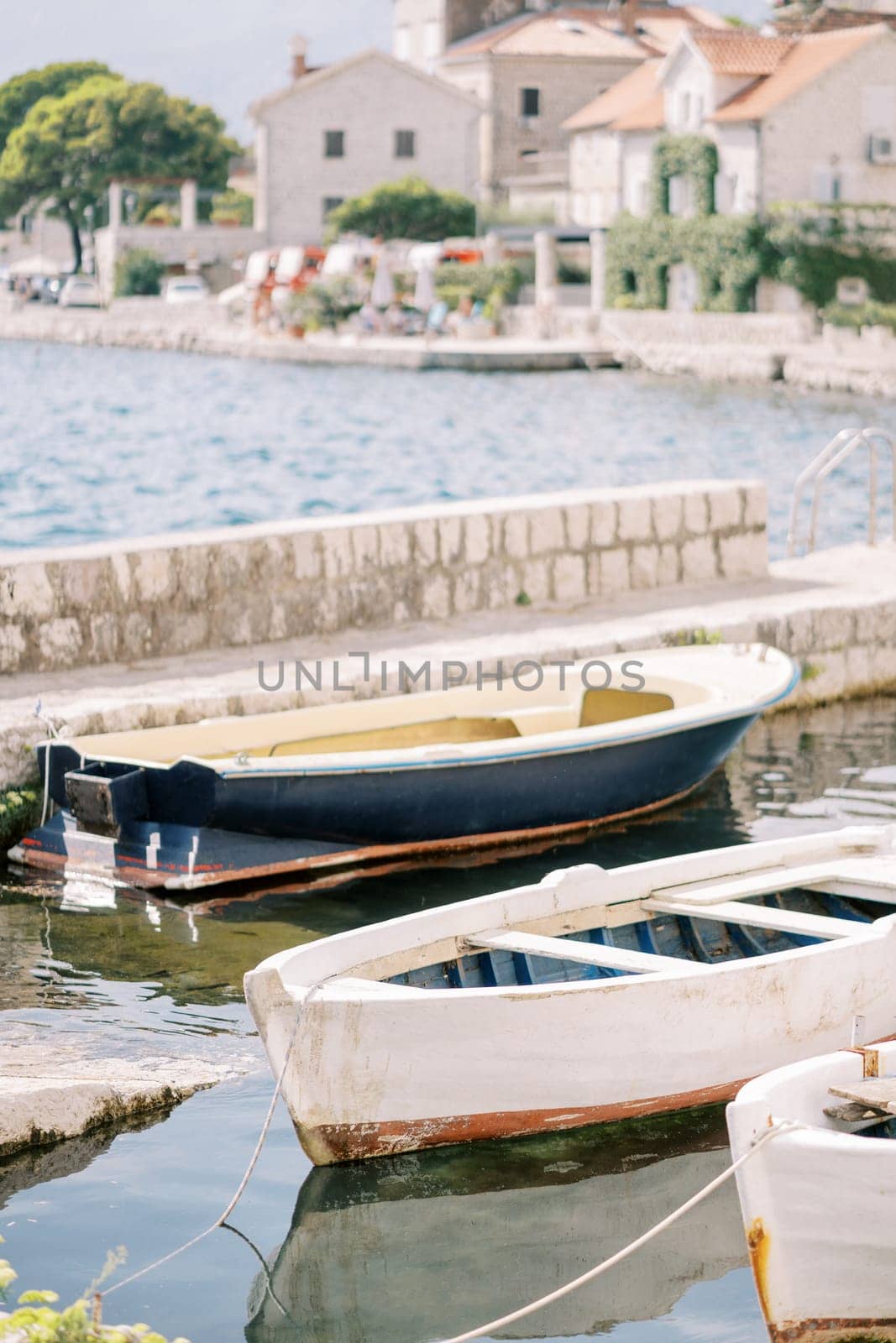 Colorful wooden fishing boats are moored near the Perast pier. Montenegro. High quality photo
