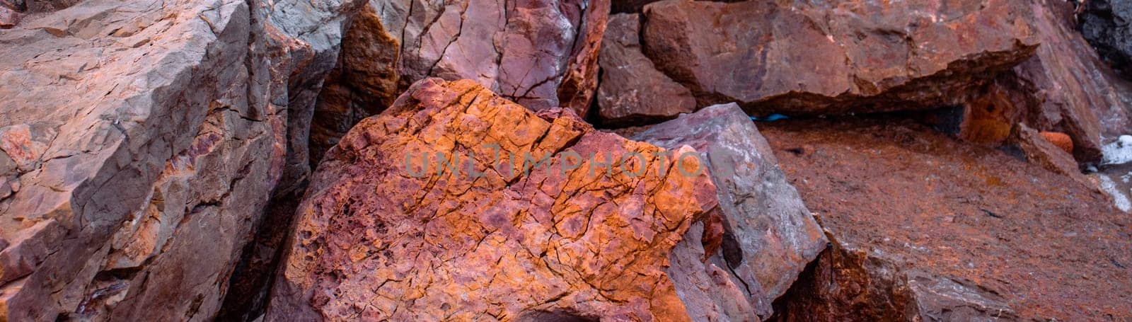 Seaside textured red rocks concept photo. Wide banner of rough surface. Panoramic Mediterranean sea by _Nataly_Nati_