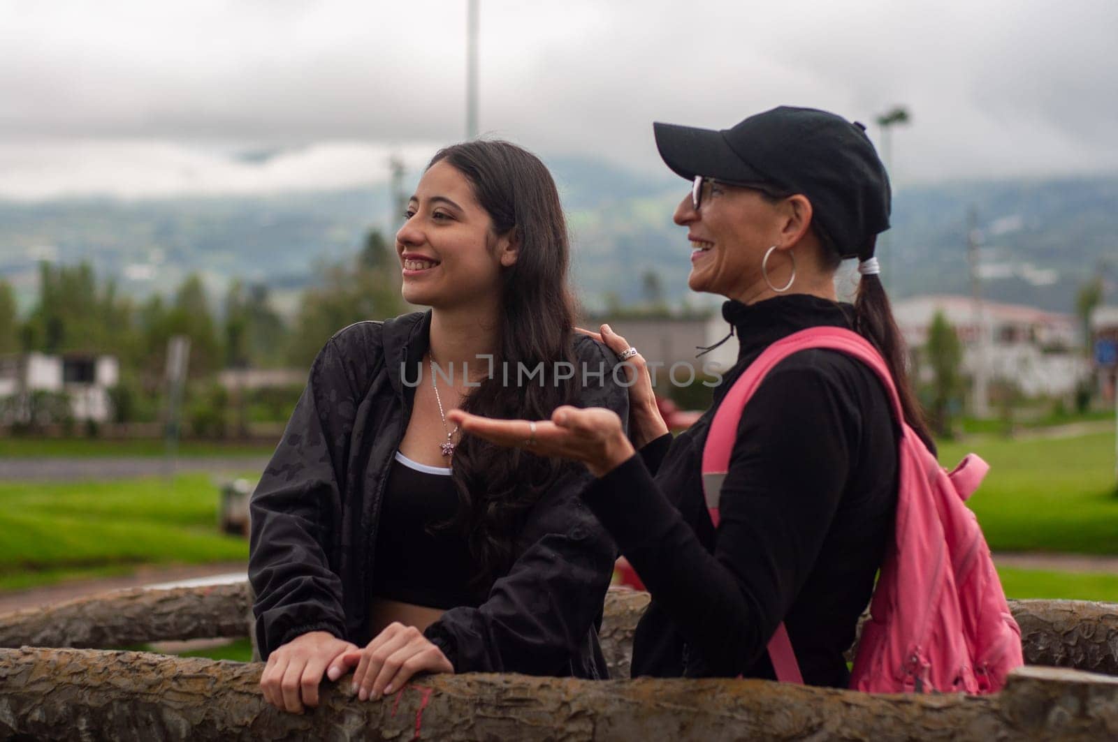 mother sharing with her daughter a pleasant moment in a park in the early morning. march 8. women's day. High quality photo