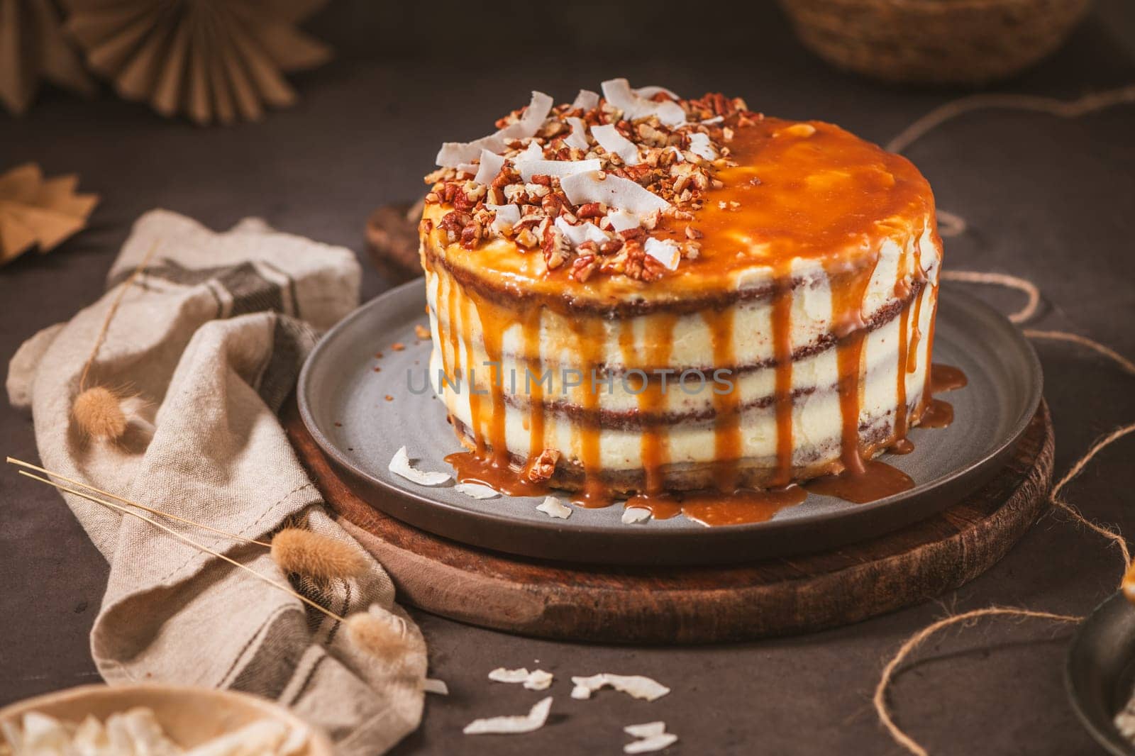 Delicious caramel cake with small pieces of pecan nuts and coconut shavings.