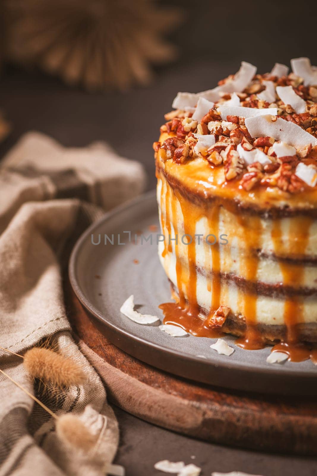 Delicious caramel cake with small pieces of pecan nuts and coconut shavings.