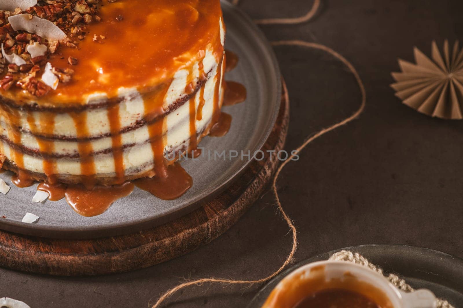 Delicious caramel cake with small pieces of pecan nuts and coconut shavings.