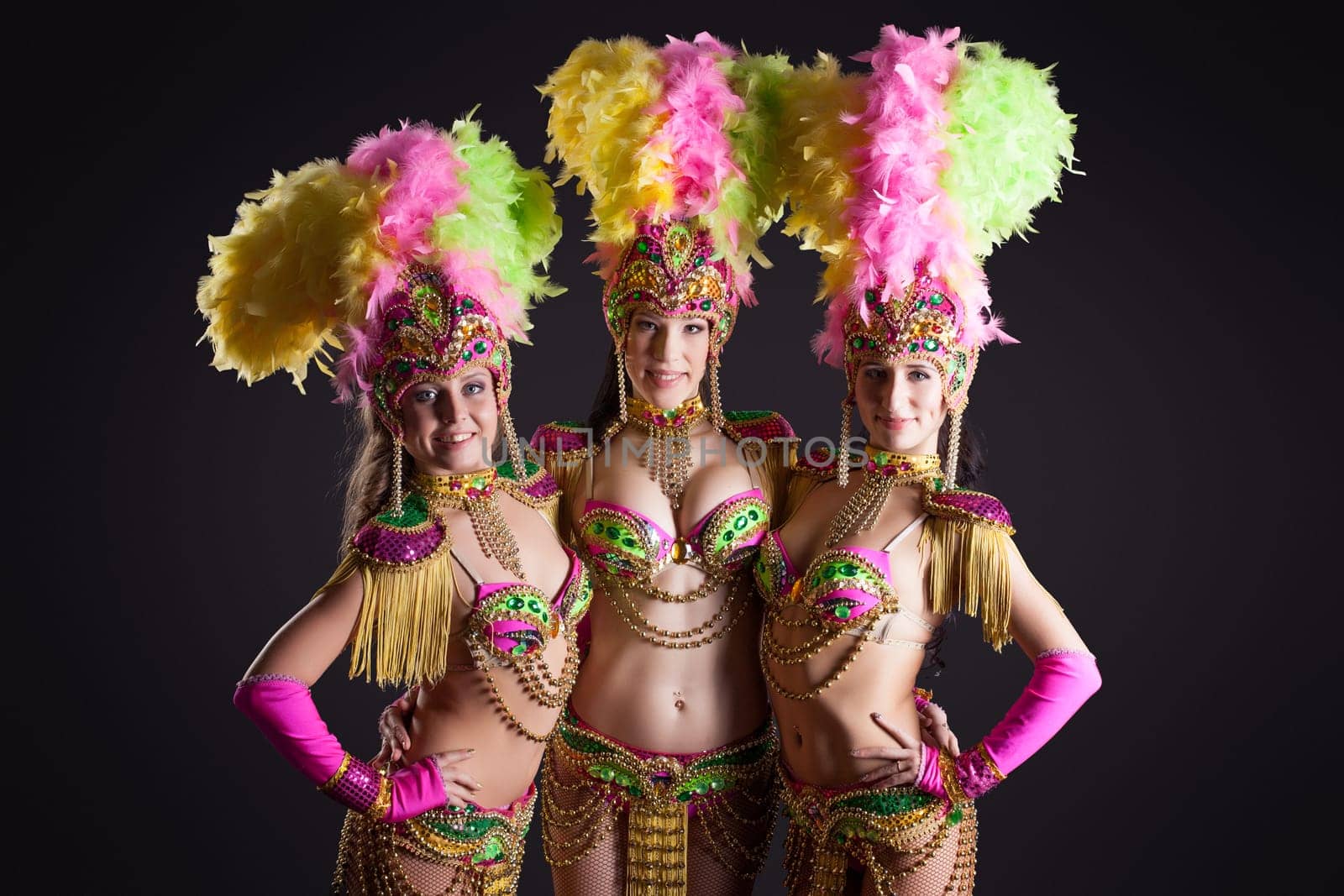 Studio shot of pretty carnival dancers posing at camera