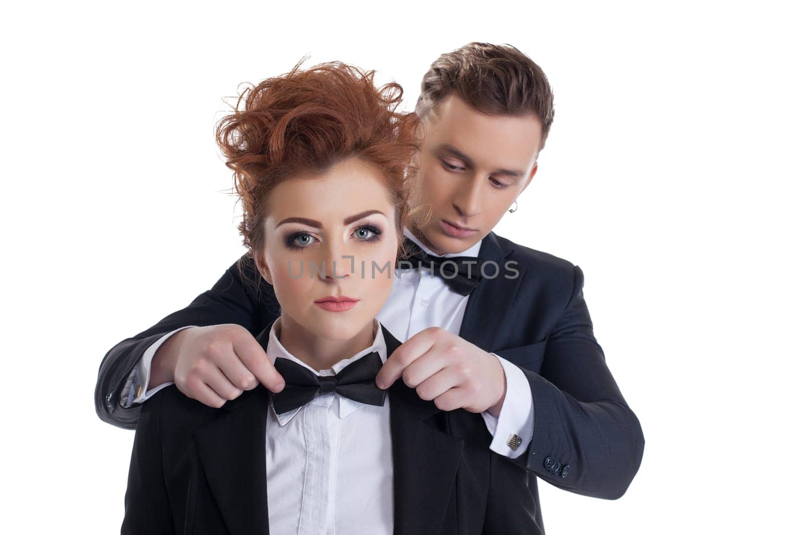 Image of gallant man straightens tie to his sexy girlfriend