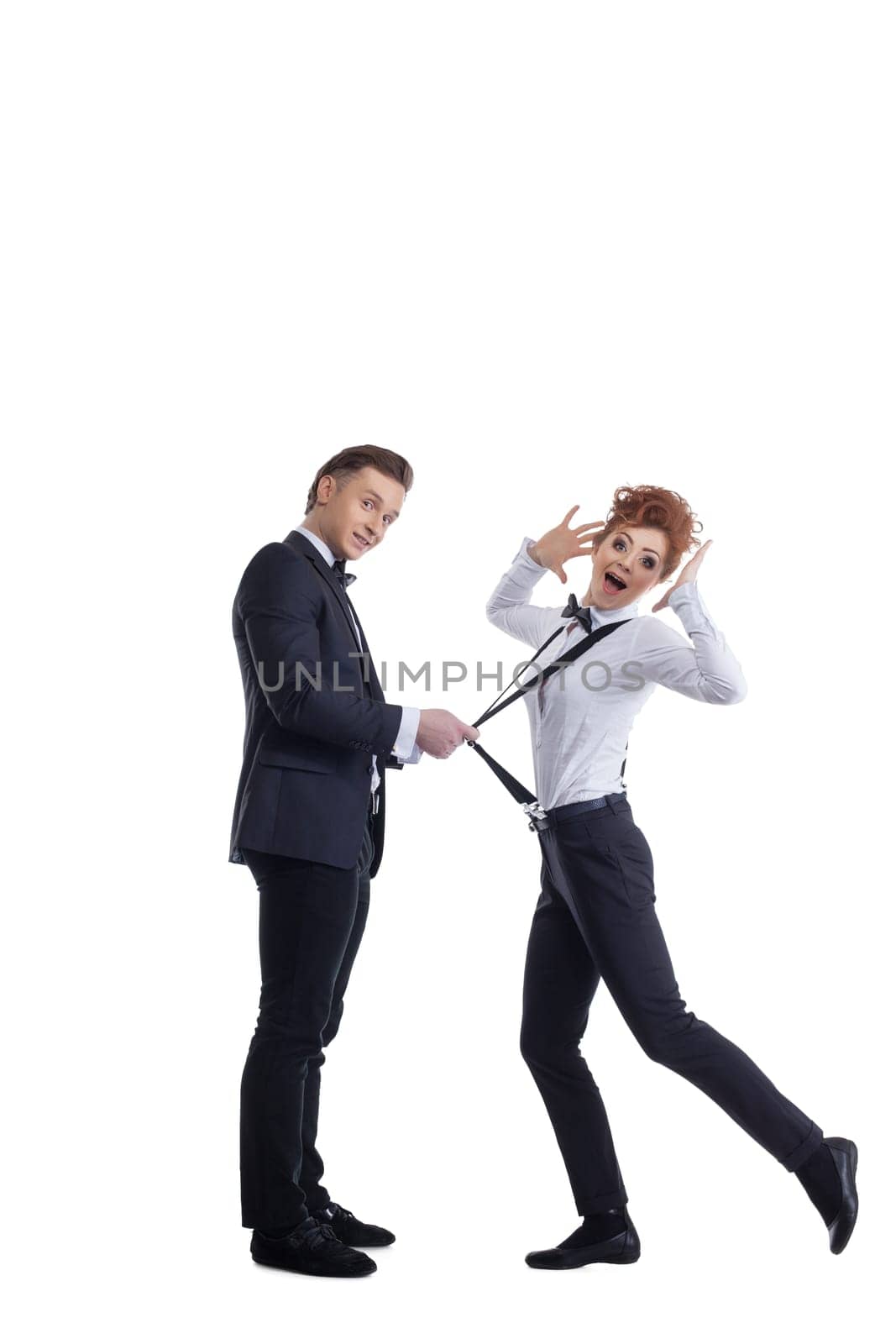Cute man pulls girl's suspenders and she's smiling, Isolated on white background