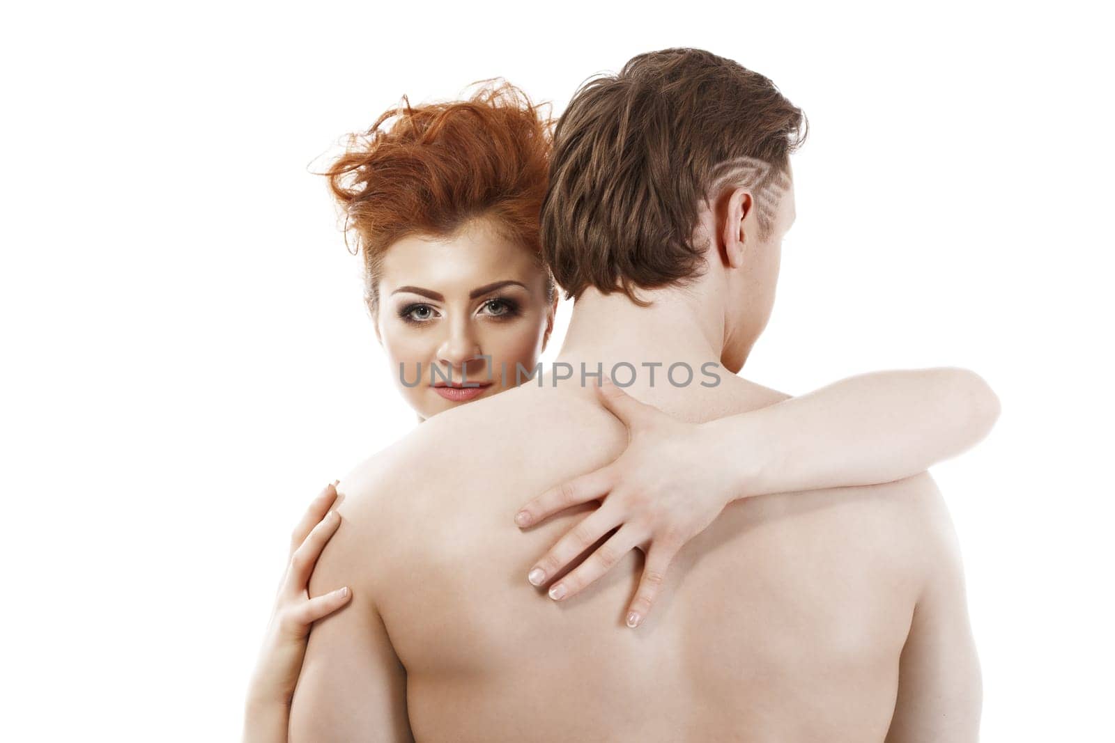 Confident red-haired beauty imperious hugging man, isolated on white
