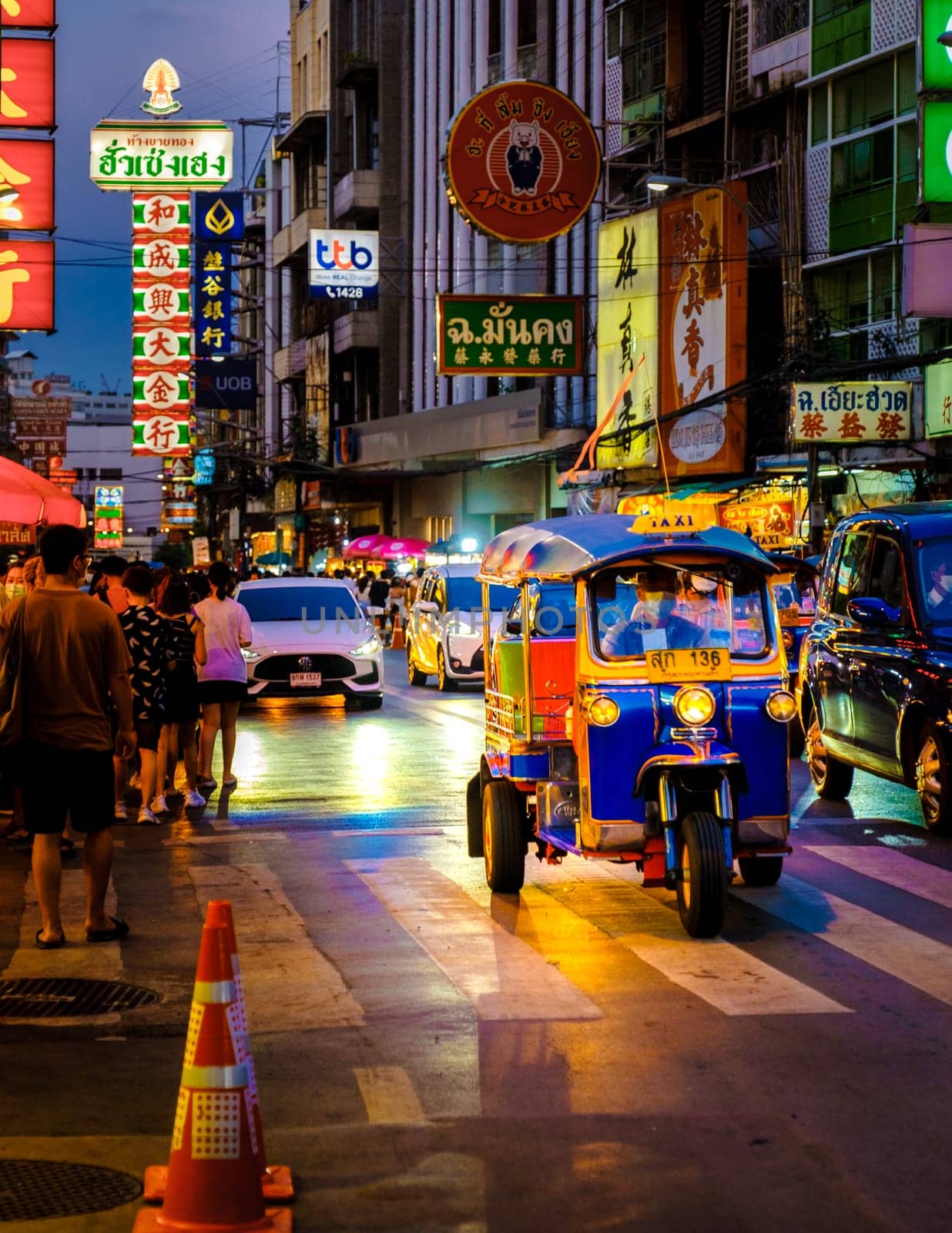 colorful tuk tuk in the city China town with neon lights by fokkebok