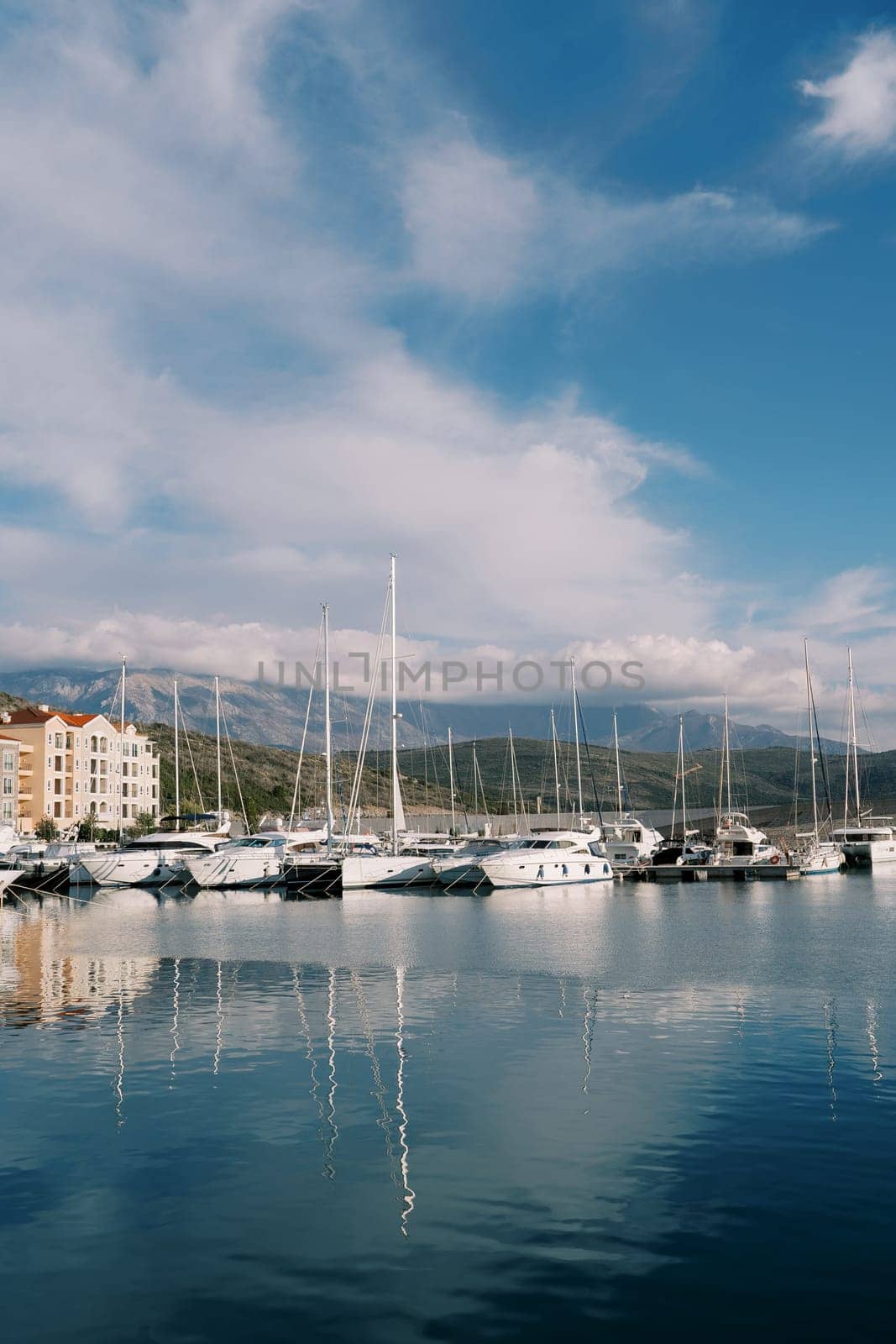 Yachts are moored at the Lustica Bay marina. Montenegro by Nadtochiy