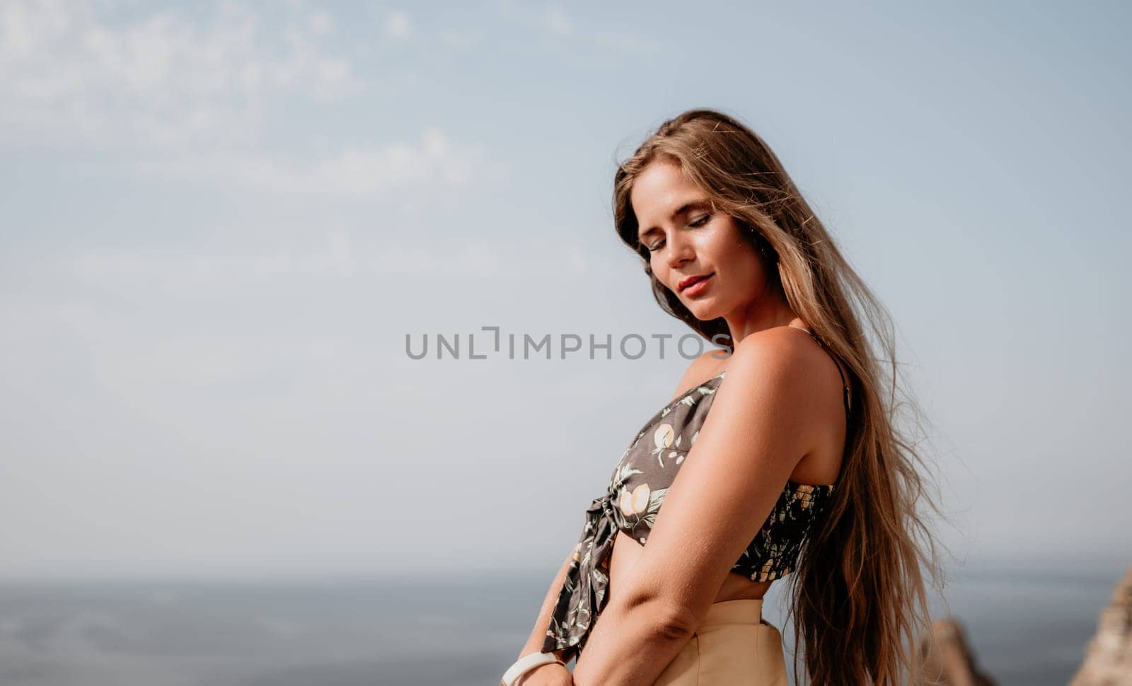 Woman travel sea. Happy tourist taking picture outdoors for memories. Woman traveler looks at the edge of the cliff on the sea bay of mountains, sharing travel adventure journey by panophotograph