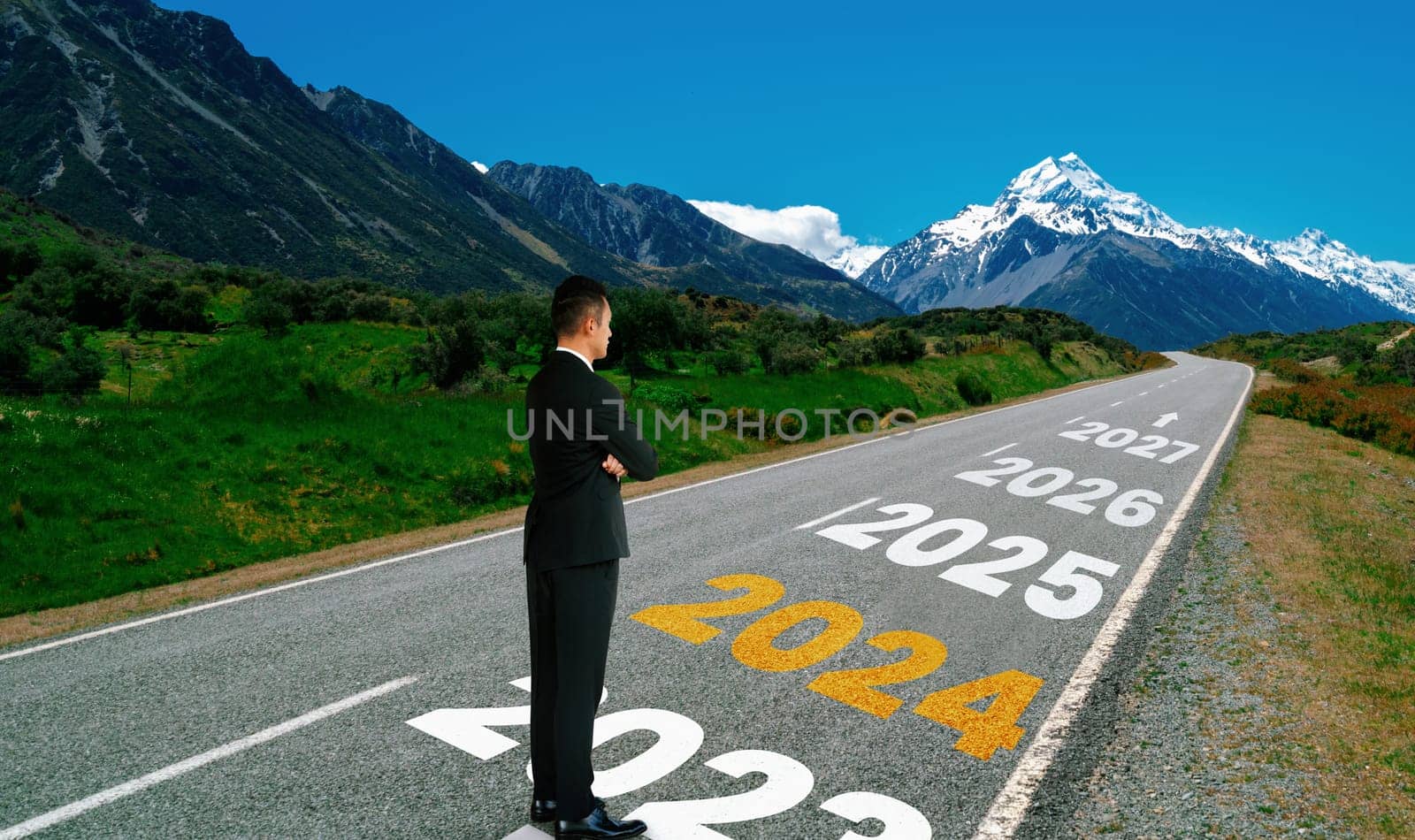 2024 New Year journey and future vision concept . Businessman traveling on highway road leading forward to happy new year celebration in beginning of 2024 for bliss and successful start .