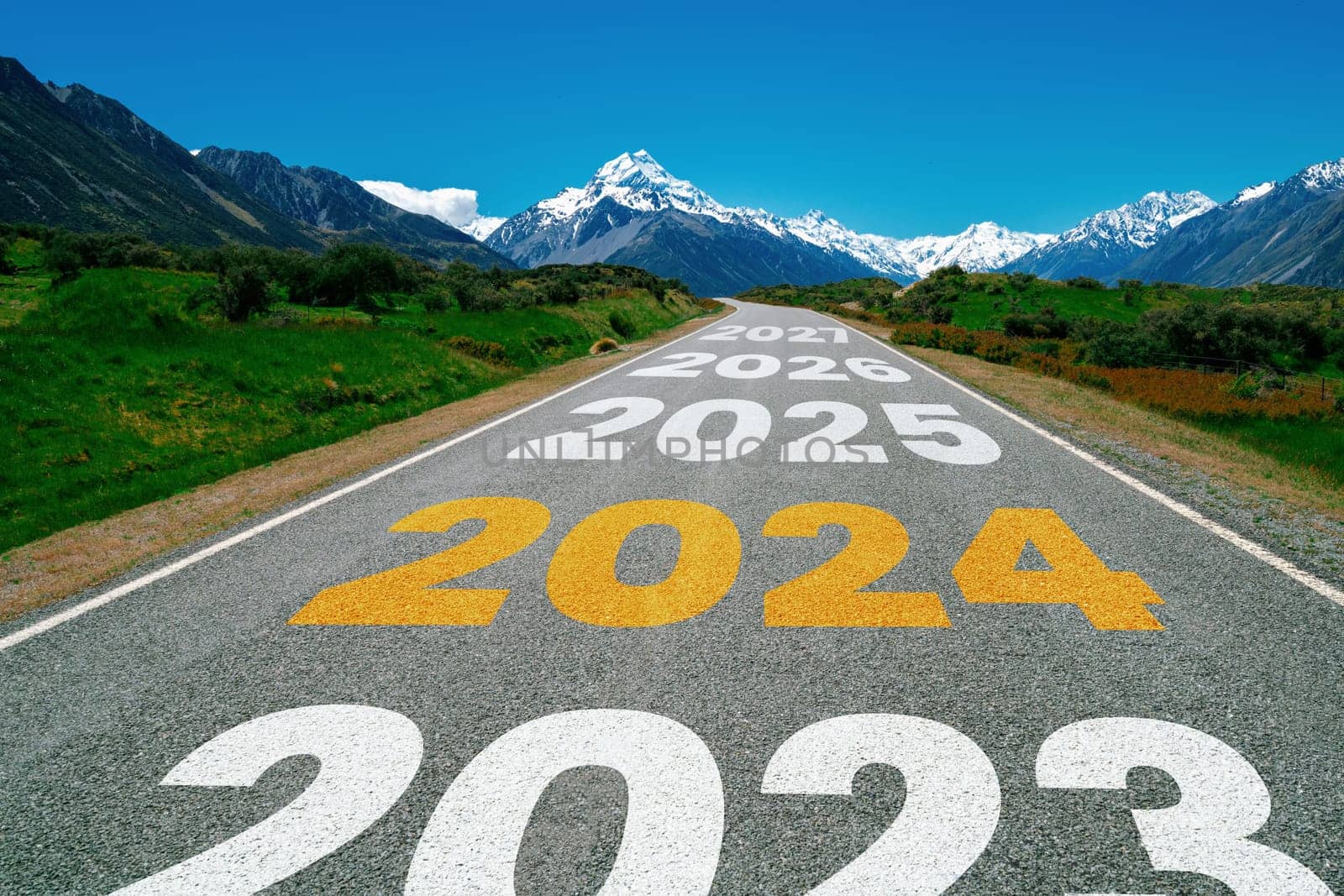 2024 New Year road trip travel and future vision concept . Nature landscape with highway road leading forward to happy new year celebration in the beginning of 2024 for bliss and successful start .