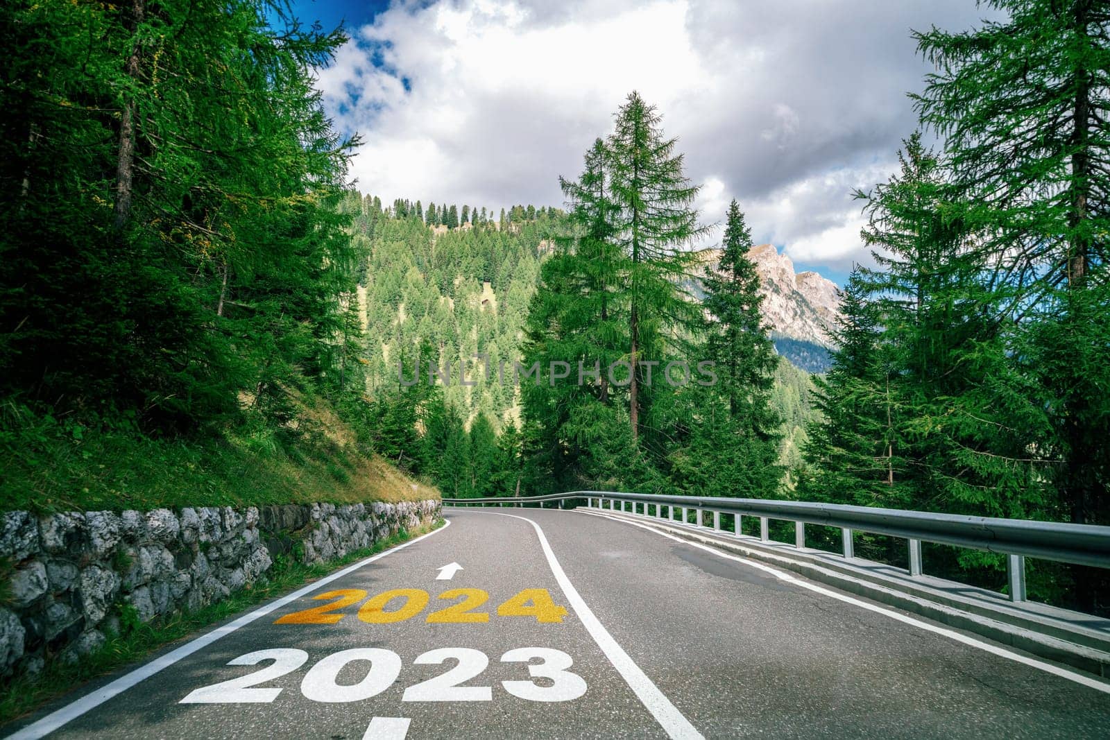 2024 New Year road trip travel and future vision concept . Nature landscape with highway road leading forward to happy new year celebration in the beginning of 2024 for bliss and successful start .