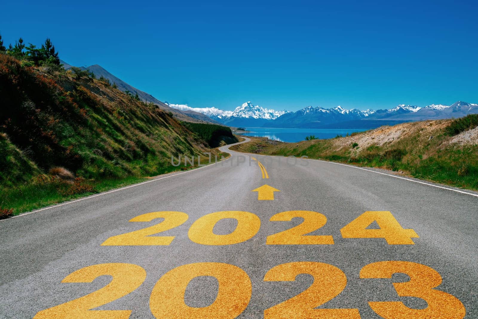 2024 New Year road trip travel and future vision concept . Nature landscape with highway road leading forward to happy new year celebration in the beginning of 2024 for bliss and successful start .