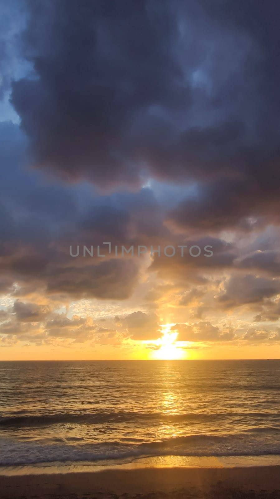 Seascape with beautiful sunset on horizon line and clouds, vertical frame. by Laguna781