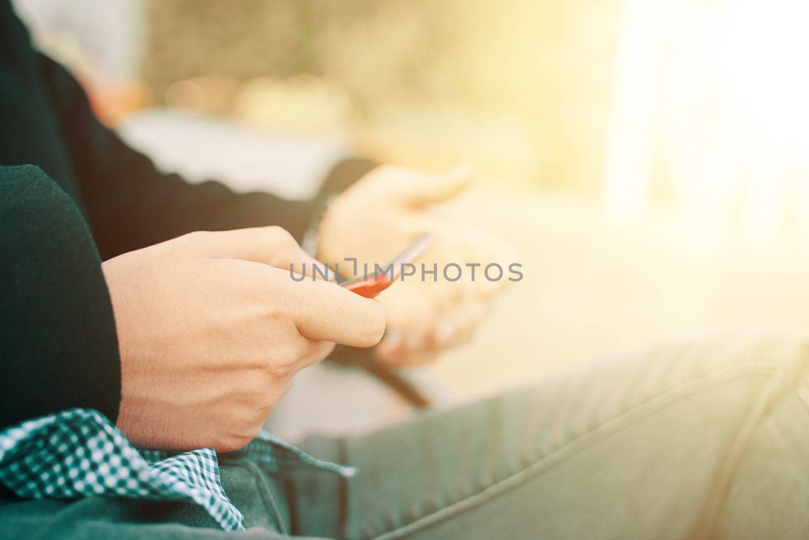 Man using smartphone. Boy uses the phone, teenager hands texting on smartphone, close up.