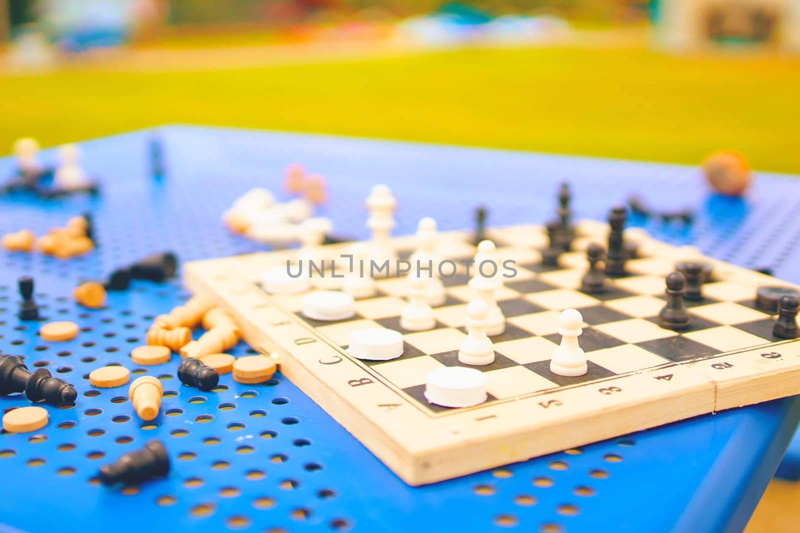 Scattered chess summer day on the blue table in the Park