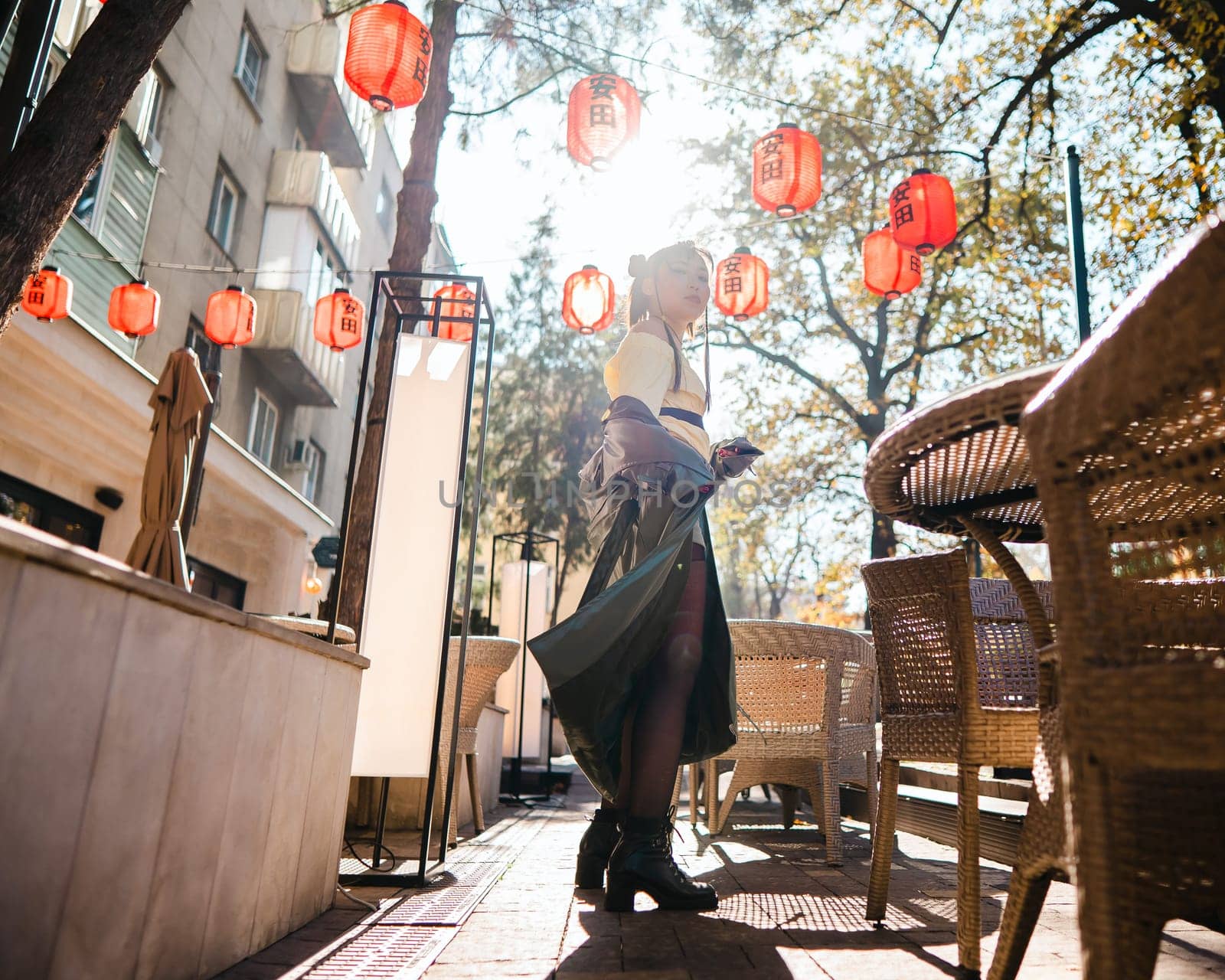 Portrait of an Asian woman against the background of Chinese lanterns outdoors