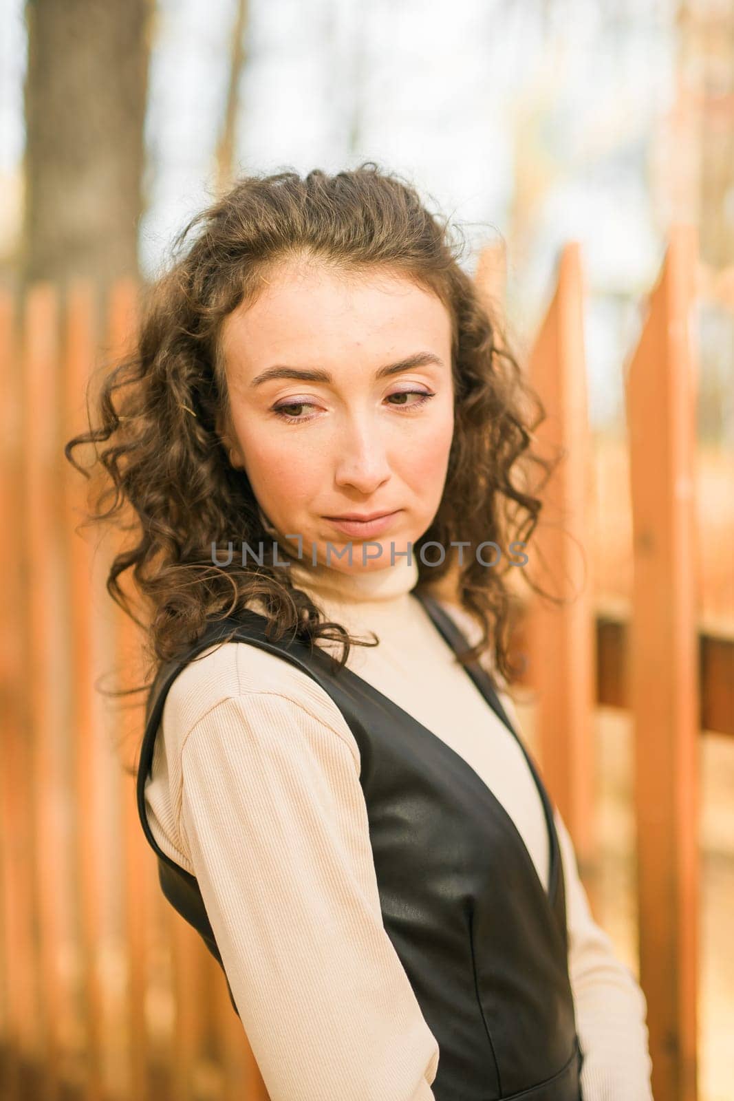 Autumn portrait of a beautiful happy curly woman in fall season. Millennial generation female. Natural beauty concept by Satura86