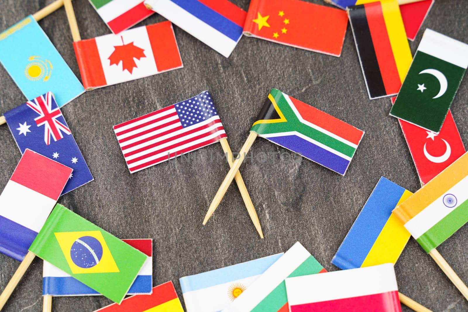 Policy. National flags of different countries. The concept is diplomacy. In the middle among the various flags are two flags - USA, South Africa