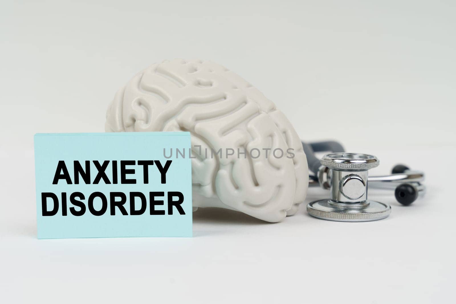 Medical concept. On a white surface next to the brain there is a stethoscope and stickers with the inscription - Anxiety disorder