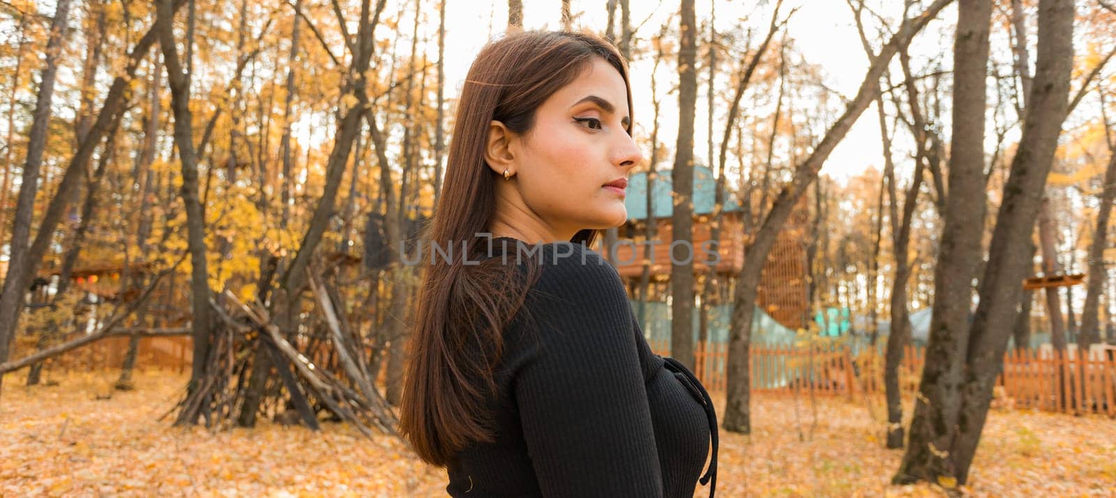 Banner portrait of diversity young beautiful confident Indian Asian woman in black dress in fall outdoor copy space mockup. Happy and natural smiling female. Generation z and gen z youth concept by Satura86