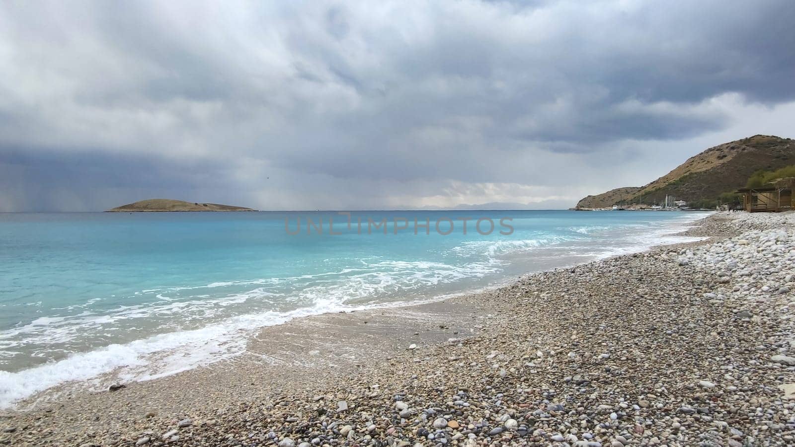 Panorama of sea coast, stormy sky over turquoise sea, view from shore by Laguna781