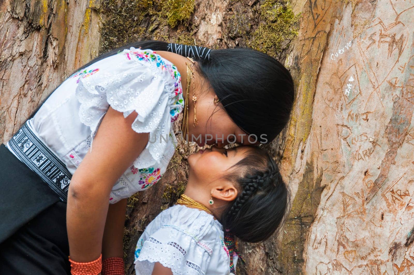 indigenous mother and daughter enjoying motherhood through games in a rural environment. women's day. by Raulmartin