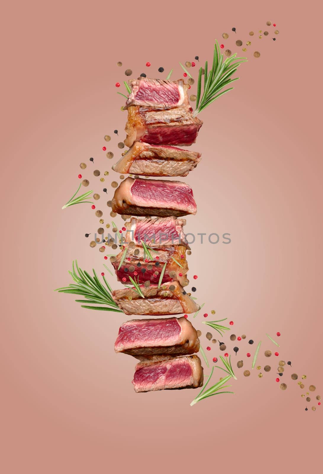Sliced fried beef steak New York with spices and a sprig of rosemary, degree of doneness rare by ndanko