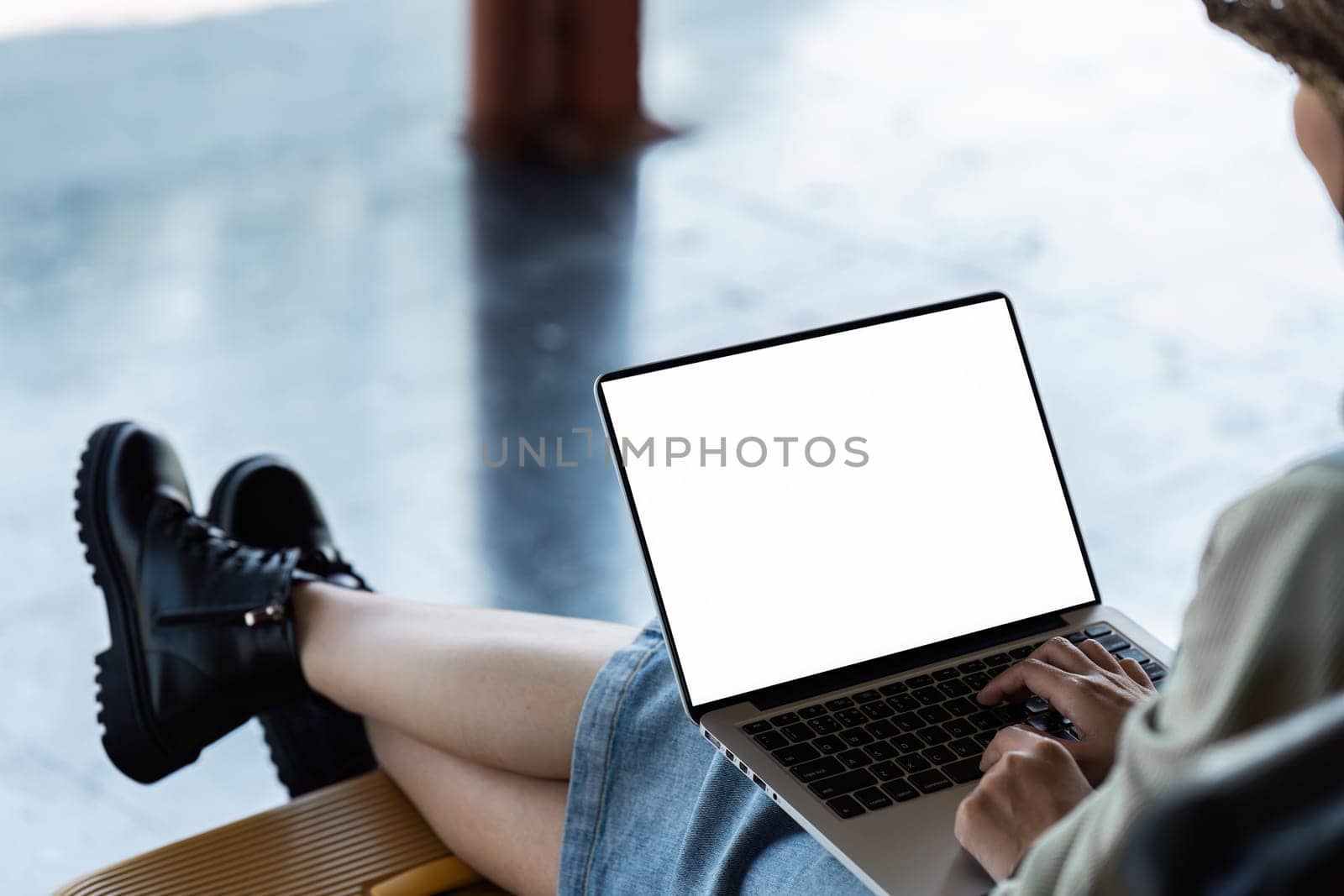 woman freelancer using laptop working online on railway station. Business trip concept by itchaznong