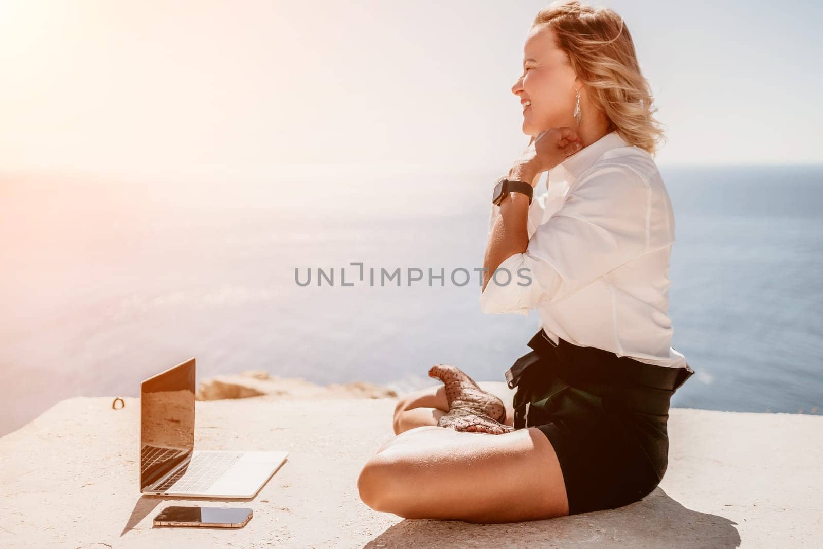 Woman sea laptop yoga. Business woman freelancer in yoga pose working over blue sea beach at laptop and meditates. Girl relieves stress from work. Freelance, digital nomad, travel and holidays concept by panophotograph