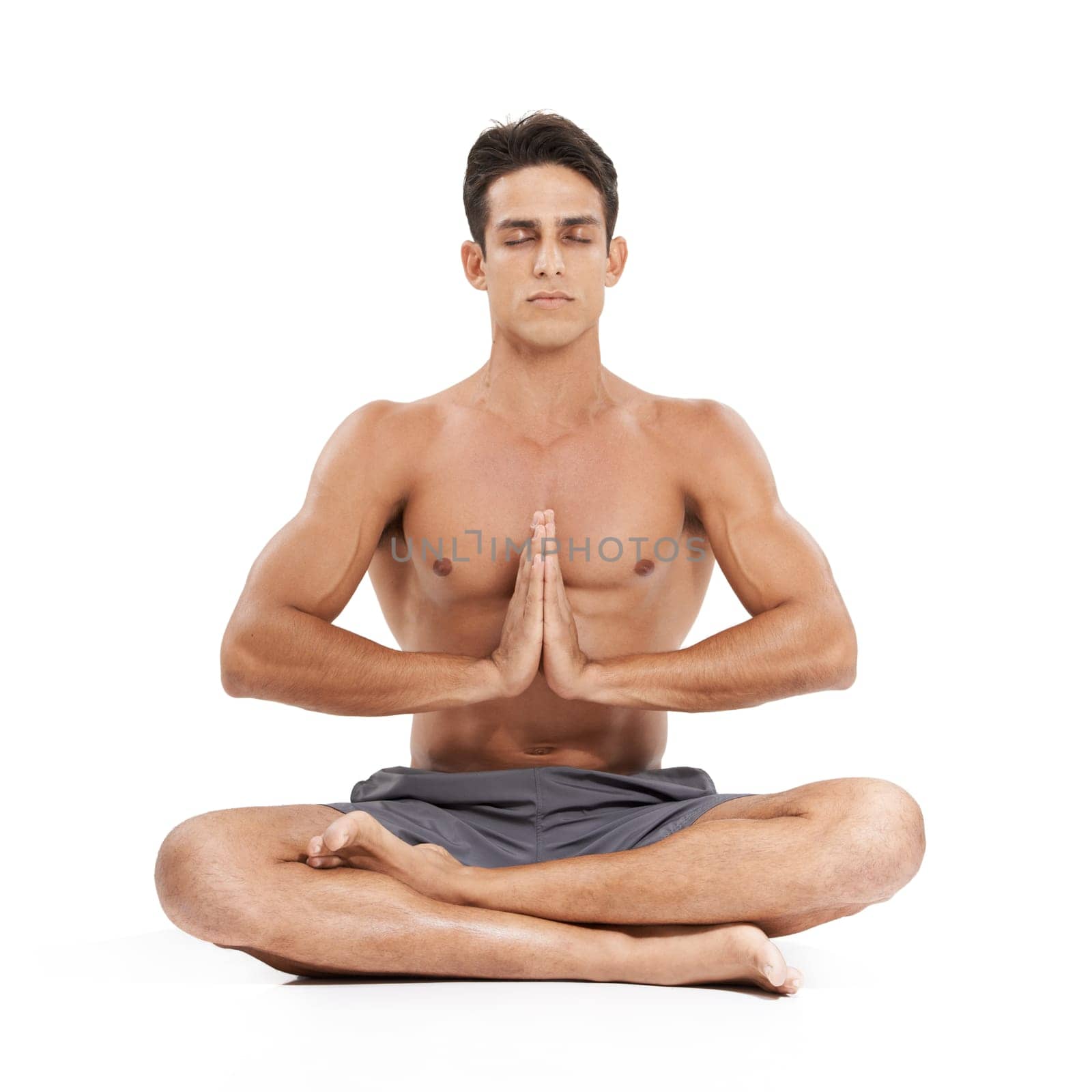 Man, meditation and yoga in studio for mindfulness or spiritual awareness, zen and namaste pose. Male person, pilates and peace or wellness and healing or relax, fitness and calm by white background.