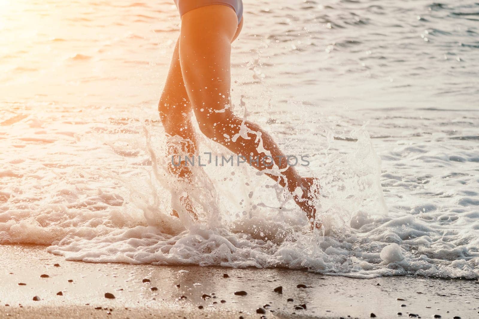 Running woman. Female runner jogging during the sunrise on beach. Woman Runner feet running on the beach at sunrise. woman fitness sunrise jog workout wellness concept.