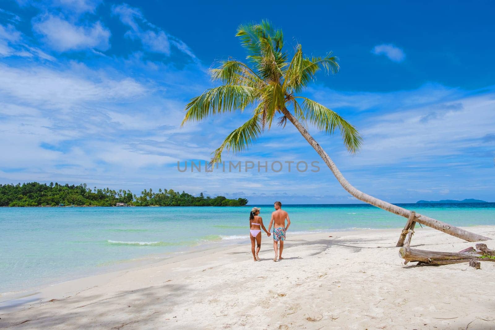 Tropical Island Koh Kood or Koh Kut Thailand. Couple men and women on vacation in Thailand walking at the beach, holiday concept Island hopping in Eastern Thailand Trang