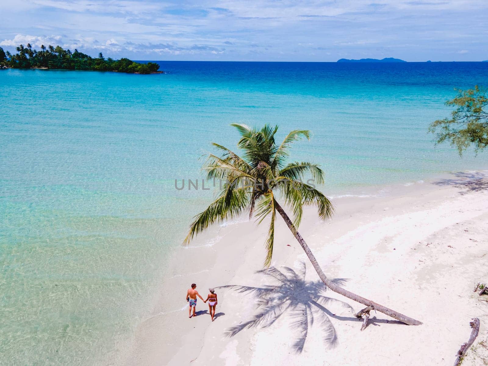 Tropical Island Koh Kood Thailand. Couple men and women on vacation in Thailand walking at the beach, holiday concept Island hopping in Eastern Thailand Trang