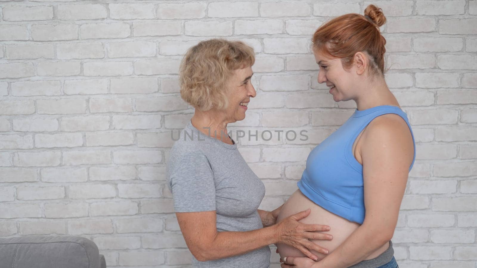 Elderly woman and her adult pregnant daughter. by mrwed54