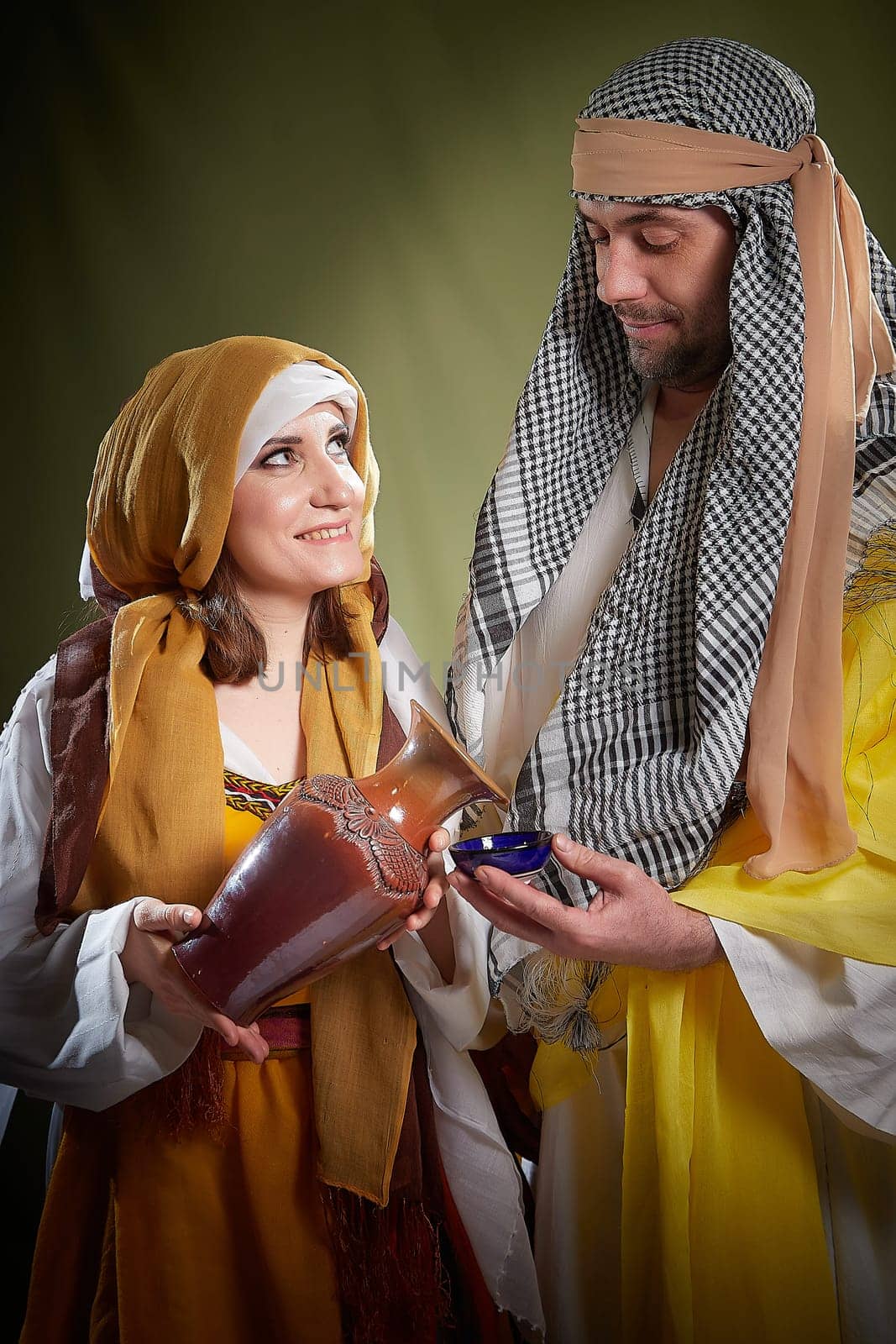 A couple in love or a married couple in stylized Eastern clothing from Israel, Palestine, Iran, Pakistan together. Tender photo session in the style of the Middle East and the Bible