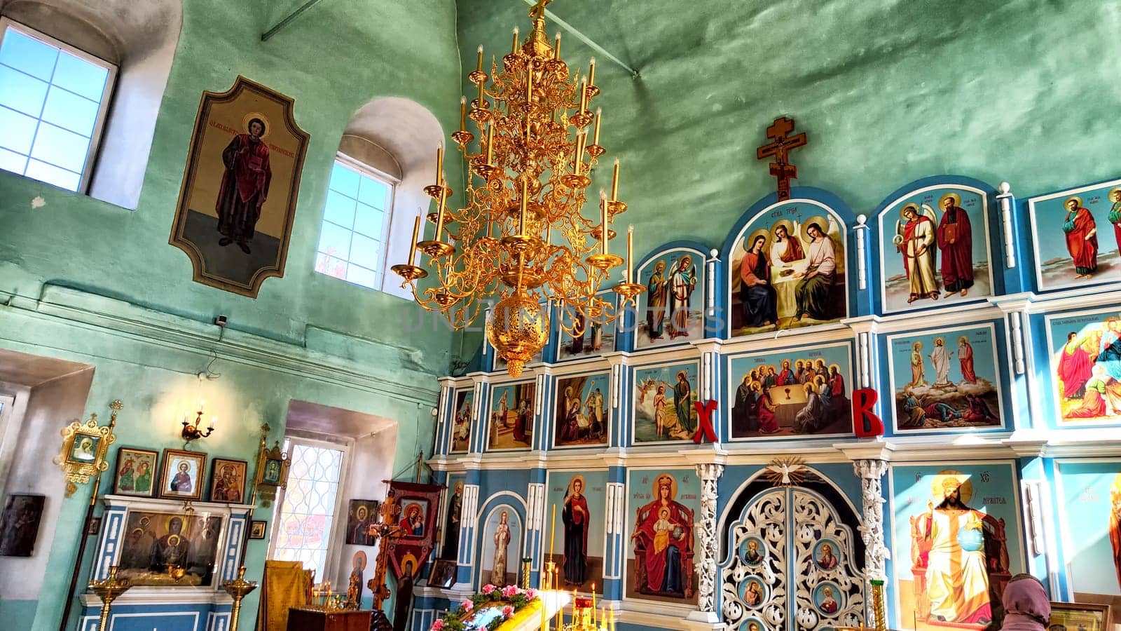 Kirov, Russia - April 09, 2023: Russian orthodox church inside. The unidentified christians people pray. The church candles as background by keleny